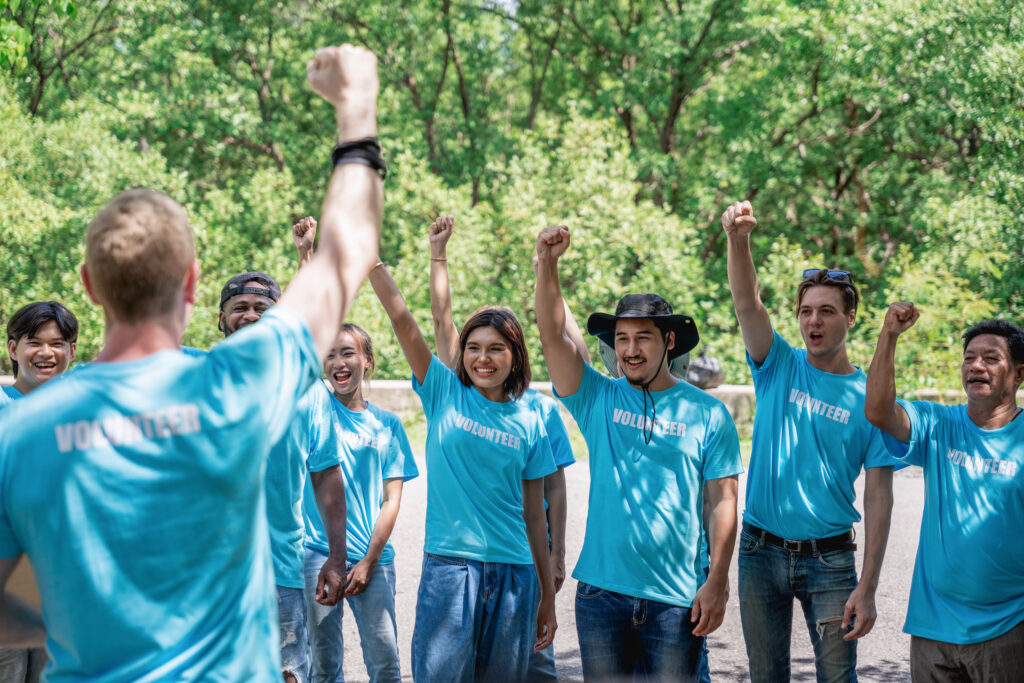 Group of volunteers for charity preparing for work in the forest park area.